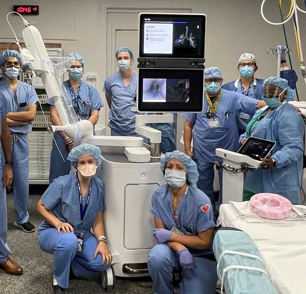 Dr. Hena in the robotic bronchoscopy suite, along with the interventional pulmonary and thoracic surgery team.