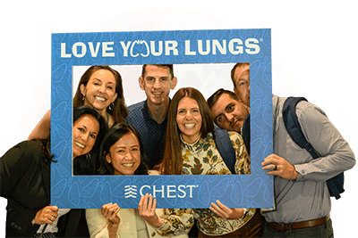 Annual Meeting attendees posing with a Love Your Lungs frame