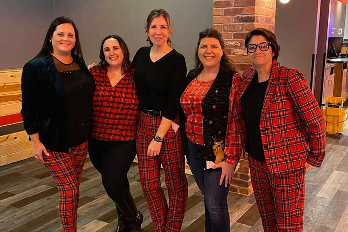 Matching CHEST staff members enjoy the 2024 holiday party at Bowlero